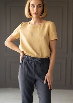 "FREE WORLDWIDE EXPRESS SHIPPING on all orders*  (*except fabric samples) Absolute basic linen shirt that is easy-to-wear everywhere and goes well together with every bottom you already have. Guaranteed to become one of your favorites in warm-weather wardrobe.  FABRIC: 100% Softened Lithuanian Linen COLOR: Please choose the desired color from the side menu.  STYLE: Linen shirt with short sleeves and hem back.  SIZE CHART (body measurements):  XS Bust 28- 31\" (72- 79 cm) Waist 20- 22.5\" (51- 58 cm) Hips 31.5 -34.5\" (80- 87 cm) S Bust 31.5- 35\" (80- 88 cm) Waist 23- 26.5\" (59- 68 cm) Hips 35- 38\" (88- 96 cm) M Bust 35- 38\" (89- 96 cm) Waist 27- 30\" (69- 76 cm) Hips 38- 41\" (97- 104 cm) L Bust 38- 41\" (97- 104 cm) Waist 30.5- 33\" (77- 85 cm) Hips 41- 44\" (105- 112 cm) XL Bust 41.5 Linen Crew Neck Top For Work, Summer Workwear Tops In Flax Color, Linen Relaxed Fit Tops For Workwear, Relaxed Fit Linen Tops For Workwear, Solid Linen Tops For Work, Solid Linen Top For Work, Linen Workwear Top, Relaxed Fit Linen Blouse In Flax Color, Relaxed Fit Linen Tops In Flax Color