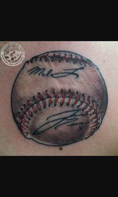 a baseball tattoo on the back of a man's shoulder