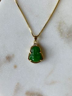 NEW ITEM & FREE SHIPPING This necklace is perfect for those that love dainty jewelry and small charms, the pendant is roughly the size of a dime and is perfect for layering with other necklaces. The pendant holds a Buddha gemstone made of genuine hand carved jade, with a .925 Sterling Silver frame and 18 inch box chain dipped in 14K gold. This chain is tarnish proof: You can shower with it, swim, and have contact with water. This necklace is perfect for gifting: I can include a handwritten n Jade Buddha Necklace, Jade Buddha, Tiny Buddha, Buddha Necklace, Carved Jade, Buddha Pendant, Small Charms, Jade Carving, Green Jade