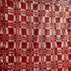 a red and white checkered fabric with small squares on the top, as well as dots in the middle