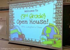 a large projection screen in the middle of a school hallway with an open house sign on it