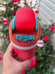 someone is holding up a red cup with sprinkles and the word vegan on it