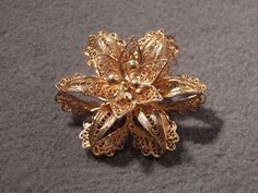 I am offering you this most enchanting vintage sterling silver (tested positive for sterling silver 925 content) with gold overlay brooch. There are so many exciting design elements to this piece, it is sensational! It features a lovely fancy intricate filigree floral design, so fabulous! The brooch measures approx. 1 1/4 inches in diameter, and its breathtaking There is a secure safety locking closure pin back. Glamorous brooches like this are a hot current fashion trend this season, a must for Floral Brooch, Current Fashion, Gold Overlay, Brooch Jewelry, Current Fashion Trends, Fashion Trend, Vintage Sterling Silver, Silver 925, Vintage Designs