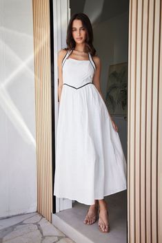 The Whitney Maxi Dress exudes effortless elegance, made from smooth polyester. Its flattering maxi length and backless design add sophistication, while the halterneck offers modern allure. Perfect for any occasion, this dress lets you shine at summer soirées or formal events, clinging gracefully to your form. The Whitney Maxi Dress is your canvas for timeless elegance. LS230 Wool Winter Coat, Essential Dress, Winter Pants, White Dress Party, Backless Design, Winter Tops, Effortless Elegance, Shop Maxi Dresses, White Maxi Dresses