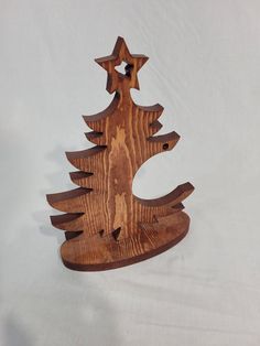 a wooden christmas tree ornament on a white background