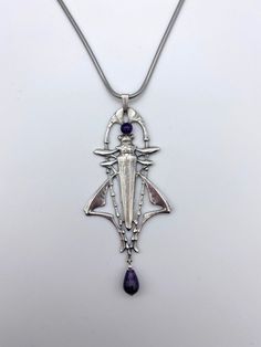 A beautiful Art Nouveau Grasshopper design set with an Amethyst cabochon and an Amethyst drop bead. It is 5 micron silver plated, nickel free and hypoallergenic. The pendant is 8 cm tall x 4 cm wide and comes with an 18 inch chain. Design Art Nouveau, Art Nouveau Pendant, Drop Beads, Design Set, Pendant Necklaces, Beautiful Necklaces, Beautiful Art, Art Nouveau, Jewelry Necklace Pendant