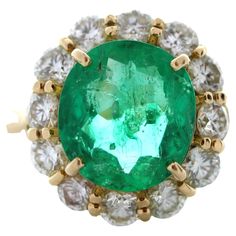 an oval emerald and diamond ring