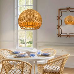 a dining room table with chairs and plates on it in front of a large window