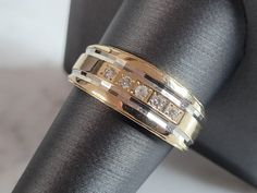 a gold ring with three diamonds on it