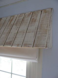 an image of a window with blinds on the top and bottom, in front of a window sill