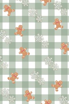 a checkered table cloth with gingerbreads and snowflakes