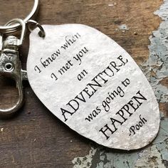 a keychain with an engraved message on it that says, i knew when i met you adventure was going to happen