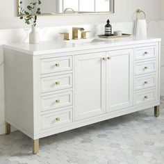 a bathroom with two sinks and mirrors on the wall next to it is white tile flooring