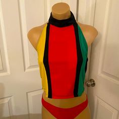 Reggae Womens Alterback Blouse Spandex/Lycra High Neck, 2 Button Closure, Elastic Secure Color:- Black, Red, Green, Yellow Handmade In Jamaica By Charmaine’s Creation Size:- Fits Up To A Medium Check Measurements Below Length ~ 16ins Armpit To Armpit ~ 15 Ins Casual Multicolor Stretch Halter Top, Fitted Multicolor Halter Top, Fitted Sleeveless Color Block Top, Fitted Color Block Beach Tops, Fitted Color Block Tops For Beach, Casual Fitted Multicolor Halter Top, Fitted Multicolor Beach Tops, Pink Velvet Top, Orange Floral Top