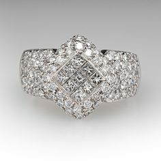 This captivating ring is centered with nine (9), invisible set, princess cut diamonds that are bordered with thirty-six (36), bead set, round brilliant cut diamonds. The shoulders of the ring are each accented with twenty-two (22), bead set, round brilliant cut diamonds. The ring measures 14.3mm at the top, rises 5.4mm above the finger, tapering to 4.4mm wide and 1.2mm thick at the base of the shank. This ring is currently a size 5.75. Fine Jewelry Square Cut Diamond Ring, Luxury Cluster Diamond Ring With Single Cut Diamonds, Dazzling Diamond White Ring With Square Cut, Dazzling Square-cut Diamond Ring With Accents, Dazzling Square Cut Diamond Ring With Accents, Timeless Square Cut Diamond Ring With Accents, Luxury White Square Cut Diamond Ring, Square Cut Platinum Diamond Ring With Accents, Luxury Diamond White Square Cut Diamond Ring