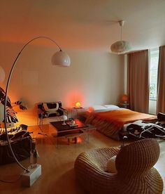 a bed room with a neatly made bed next to a chair and a table in front of a window