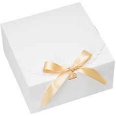 a white box with a gold ribbon on it