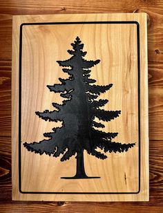 a wooden plaque with a pine tree on it