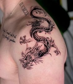 a man with a dragon tattoo on his shoulder