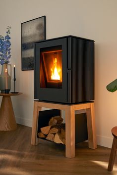 a wood burning stove sitting on top of a wooden floor