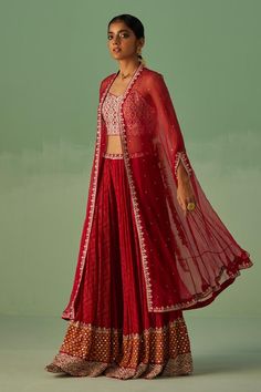 Red cape with floral embellished border. Paired with an inner blouse with mirror, dabka and beads embroidery. Comes along with a sharara with geometric print and embroidered waistband.
Components: 3
Pattern: Print, Embroidery
Type Of Work: Mirror, Dabka, Beads, Geometric, Floral
Neckline: Blouse: Sweetheart Neck
Sleeve Type: Blouse: Sleeveless
Fabric: Cape: Organza, Blouse: Dull Bosky, Sharara: Bamboo Georgette
Color: Red
Other Details: 
Length: 
Cape: 50 inches
Blouse: 15 inches
Sharara: 44 inc Festive Front Open Sharara For Party, Party Sets With Red Resham Embroidery, Traditional Front Open Palazzo Set For Party, Party Sets With Zari Work And Front Open Design, Bollywood Style Front Open Sharara For Party, Front Open Party Sets With Zari Work, Festive Front Open Traditional Wear For Party, Party Sets With Front Open Design And Zari Work, Party Sets With Front Open And Zari Work