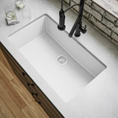 a white kitchen sink sitting on top of a counter