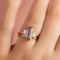 DETAILS Metal - 14k yellow gold Stone(s) - Main: 1.56ct emerald cut watermelon tourmaline Accent: 0.23tcw straight baguette and round brilliant cut diamonds Band width - 1.6mm WHY WE LOVE IT Flirty asymmetric details. This stunner features a 1.56ct slim emerald cut watermelon tourmaline set with claw prongs and accented with the coolest asymmetrical layout of round brilliant cut and baguette diamonds. This one of a kind ring can be your next everyday personal statement piece. SHIPPING + RETURNS Watermelon Tourmaline Engagement Ring, Vintage Sapphire Ring, Yellow Gold Cocktail Ring, Tourmaline Engagement Ring, Main 1, Cut Watermelon, Emerald Cut Rings, Claw Prong, Baguette Diamonds