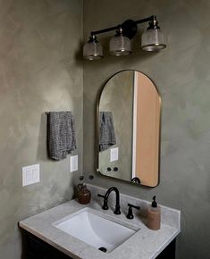 a bathroom sink with a mirror above it