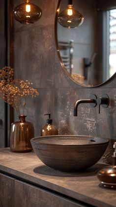 a bathroom sink sitting under a round mirror