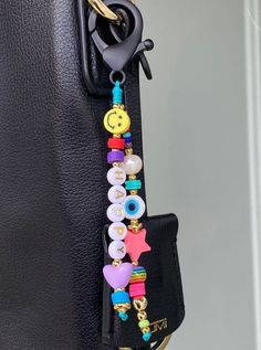 a black purse with some charms attached to it