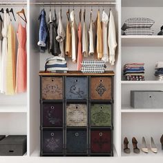 an organized closet with clothes and shoes hanging on the wall, along with shoe storage bins