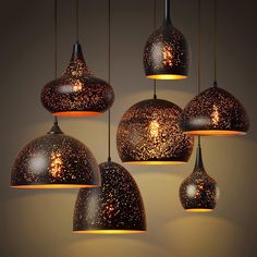 an assortment of hanging lights in various shapes and sizes, including one with stars on them