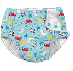 a blue diaper cover with sea animals and stars on the bottom, sitting in front of a white background