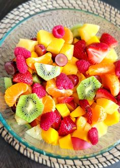 a glass bowl filled with cut up fruit