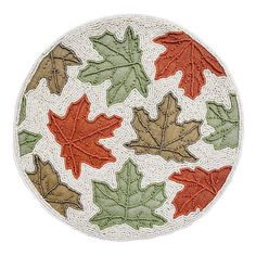 a white plate with red and green leaves on it