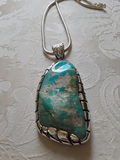 "A beautiful turquoise polished large nugget stone pendant encased with Sterling shadow box. This pendant has a large bail 16mm for large chain or bead. The pendant is 3 1/4\" long and 2\" wide, weighs 137 grams of pure beauty. This pendant does not include chain. A definite show stopper." Blue Turquoise Necklace With Large Pendant, Turquoise Large Pendant Jewelry, Collectible Large Pendant Turquoise Necklace, Elegant Turquoise Pendant Necklace With Large Stone, Vintage Turquoise Necklace With Large Pendant, Garnet Necklace, Pure Beauty, Coral Blue, Blue Chalcedony