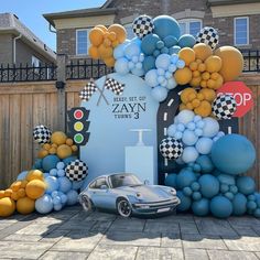 a car parked in front of a building with balloons on the wall and an entrance