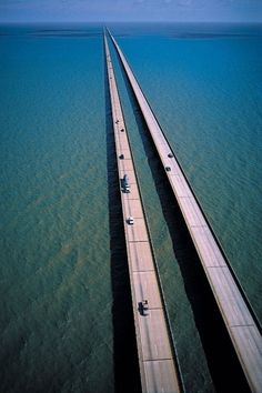 an aerial view of a long bridge spanning the ocean