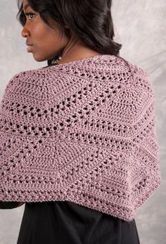 a woman wearing a pink crocheted shawl