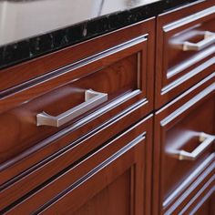 a close up of a wooden cabinet with drawers