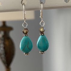 So simple and so eye catching. There's lots of sparkle from the Swarovski 5 mm crystal bronze bicone. The color of the crystal picks up the color of the fine veining in the 14 x10 mm blue green teardrop magnesite bead. Very pretty. The leverbacks are silver plated. Drop is 1 1/4 inches. Turquoise Teardrop Faceted Beads Jewelry, Turquoise Teardrop Faceted Jewelry, Turquoise Teardrop Drop Earrings, Blue Crystal Teardrop Earrings, Coin Earrings, Somerset, Jewelry Earrings Dangle, Silver Plate, Silver Plated