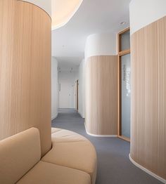 a curved couch sitting in the middle of a room