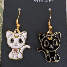 Cute Artemis and Luna Earrings from Sailor Moon! Black Moon-shaped Earrings For Gift, Black Moon Shaped Earrings For Gift, Artistic Black Nickel-free Earrings, Artsy White Pierced Earrings, Artsy White Earrings, Vintage Moon Earrings For Gift, Vintage Moon Shaped Earrings, Vintage Moon-shaped Earrings For Gift, Vintage Moon Shaped Earrings For Gift