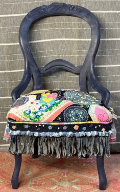 an old chair with some tassels on it