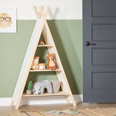 a child's room with a wooden triangle shelf