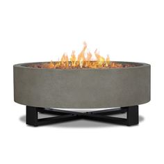 an outdoor fire pit is shown with flames coming out of the top and on it's sides