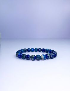 Lapis lazuli is a powerful stone for spiritual growth and enlightenment. This bracelet is designed to help you connect with the wisdom and power of lapis lazuli, and to promote your ongoing spiritual growth. The beautiful blue color of the stone is said to be associated with the divine, and wearing it can help you access your inner guidance and intuition. Blue Lapis Lazuli Gemstone Beaded Bracelet, Sapphire Lapis Lazuli Bracelets With Round Beads, Spiritual Blue Beaded Bracelets For Meditation, Adjustable Blue Crystal Bracelet For Meditation, Spiritual Blue Lapis Lazuli Beaded Bracelets, Spiritual Sapphire Beaded Bracelets With Natural Stones, Sapphire Gemstone Beads Bracelet In Lapis Lazuli, Blue Gemstone Stretch Bracelet As Gift, Spiritual Sapphire Beaded Hand-strung Bracelet