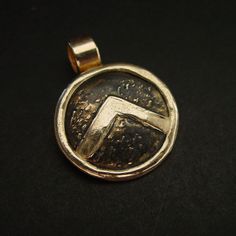 "This Spartan Shield necklace is hand sculpted, domed and beaten up to look like it has been on a battlefield. The letter lambda (Λ), standing for Laconia (administrative capital of Sparta) or Lacedaemon (ancient name for the city of Sparta), which was painted on the Spartans' shields, was first adopted in the 420s BC, and quickly became a widely known Spartan symbol. Military families passed on their shields to each generation as family heirlooms. - Hand sculpted pendant - Solid yellow bronze a Ancient Greece Jewelry, Greece Jewelry, Antique Cameo Jewelry, Gemstone Lariat Necklace, Greek Necklace, Warrior Shield, Spartan Shield, Warrior Necklace, Ancient Greek Jewelry