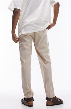 "Find TOPMAN Tapered Drawstring Pants on Editorialist. Stretchy fabric keeps you moving comfortably in these tapered drawstring pants that look smart from work to the weekend. 14\" leg opening; 11 1/2\" front rise; 16\" back rise Elastic/drawstring waist Side-seam pockets 64% polyester, 34% viscose, 2% elastane Machine wash, dry flat Imported" Summer Tapered Leg Chinos, Tapered Bottoms With Welt Pockets, Tapered Leg Pants For Summer, Casual Tapered Ankle-length Dress Pants, Relaxed Fit Tapered Bottoms For Business Casual, Business Casual Tapered Bottoms With Relaxed Fit, Business Casual Bottoms With Relaxed Tapered Fit, Summer Relaxed Fit Tapered Leg Work Pants, Tapered Leg Dress Pants With Elastic Waistband