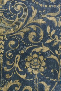 an old blue and gold wallpaper with floral designs